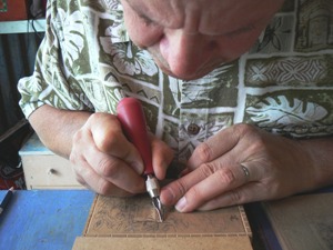 artist working over linoleum
                  plate